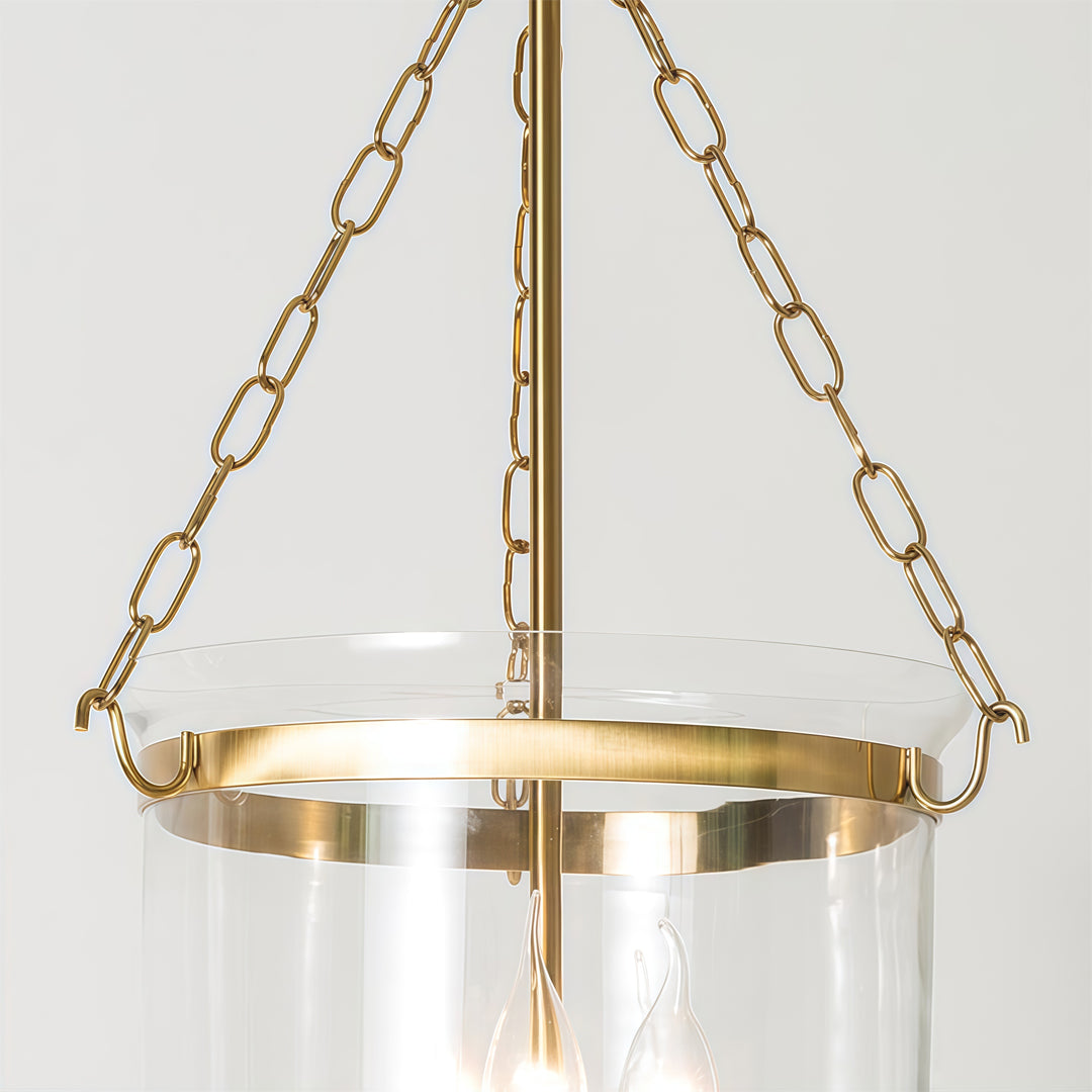 Glass chandeliers for dining room featuring elegant gold chain suspension and transparent glass shade detail.