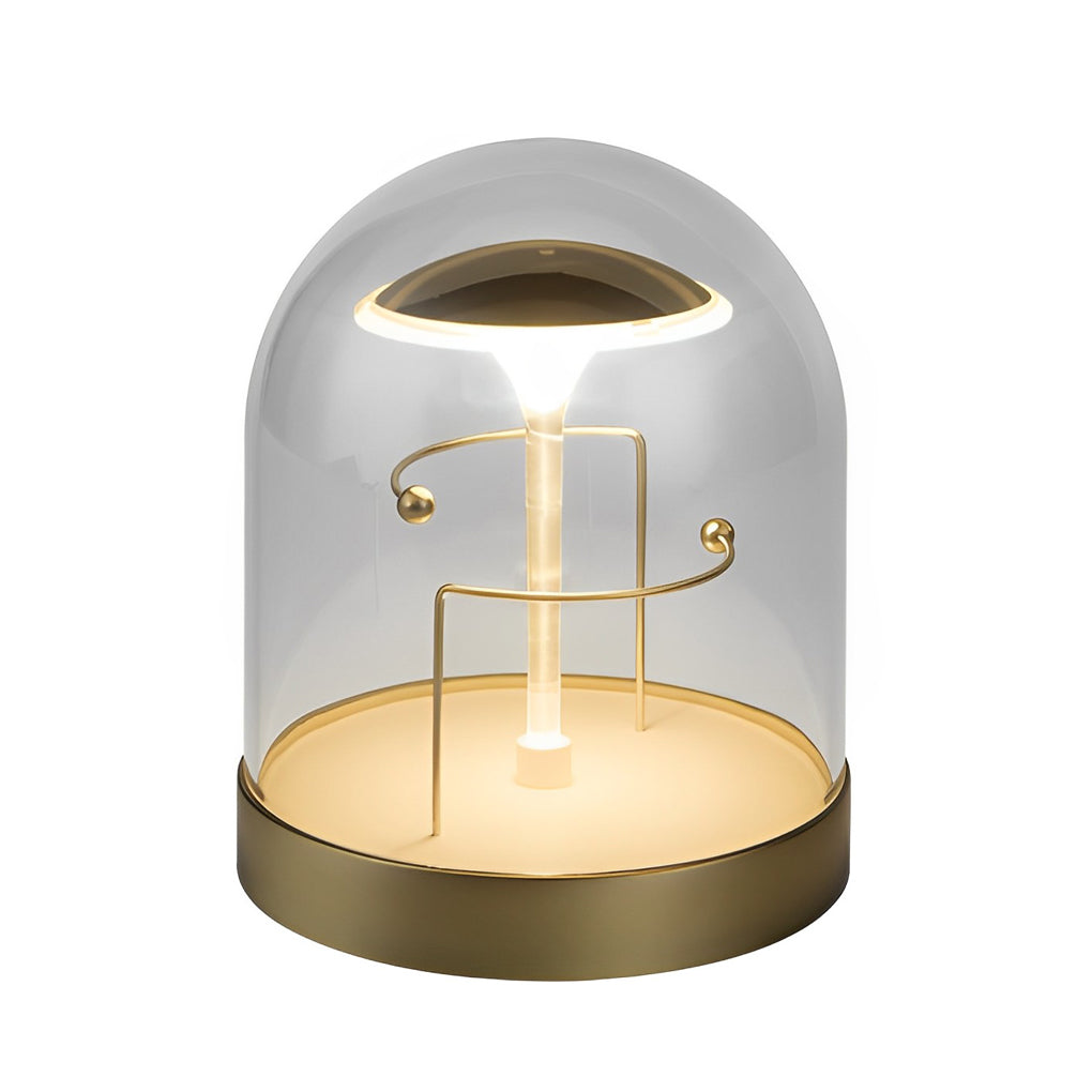 Glass dome LED lights with a gold finish, providing soft illumination on a table.