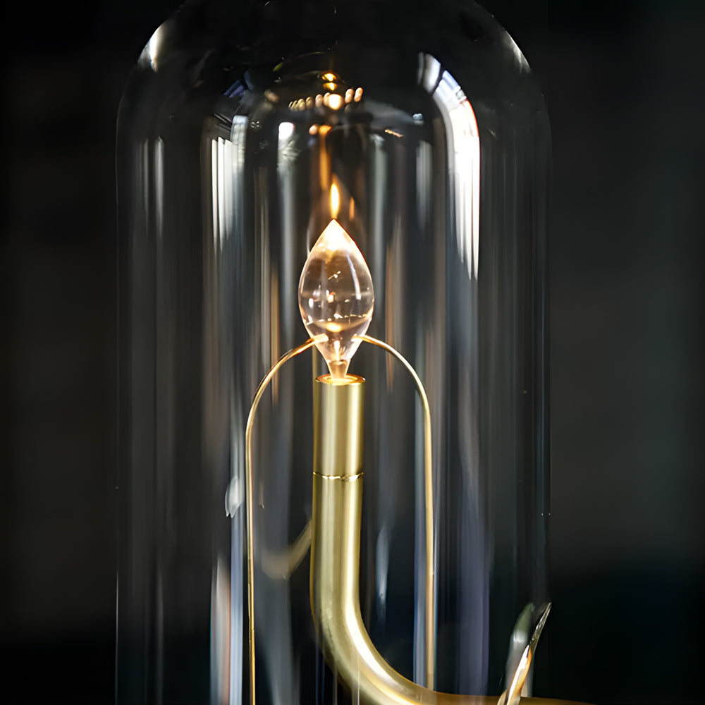 Glass dome table light in gold, front view of the sleek design.