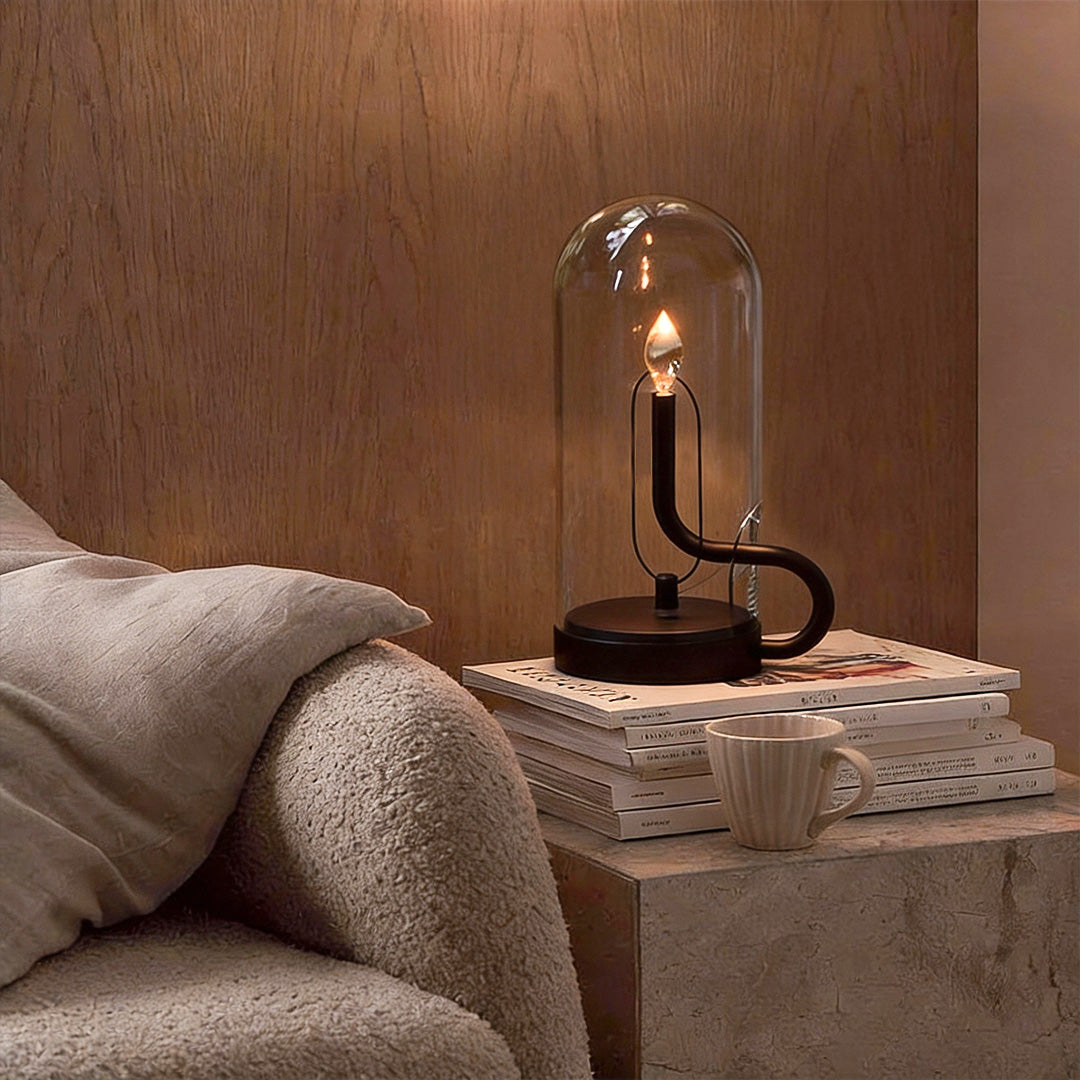 Glass dome table light providing soft light beside a modern armchair.