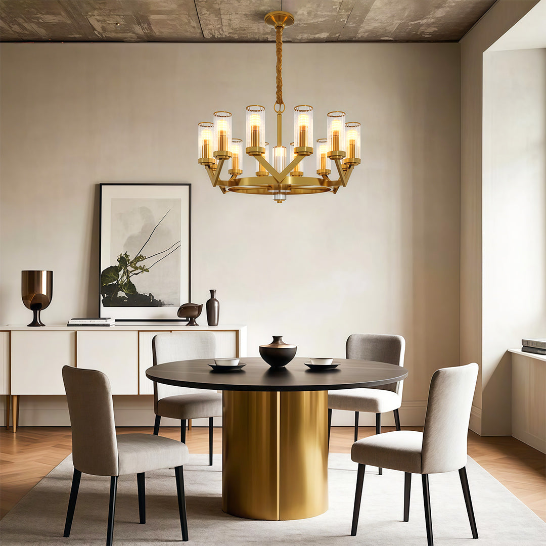Glass drop chandelier above contemporary dining table with cylindrical brass base