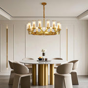 Glass drop chandelier creating focal point in minimalist dining space with fluted table