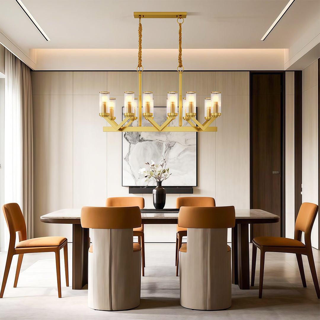 Glass drop chandelier enhancing sophisticated dining area with brass accents and modern chairs