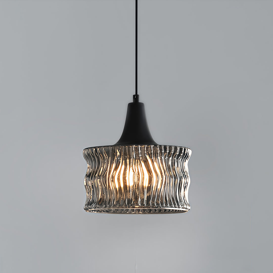 Glass drum pendant light with a detailed view of the textured glass and warm light glow.