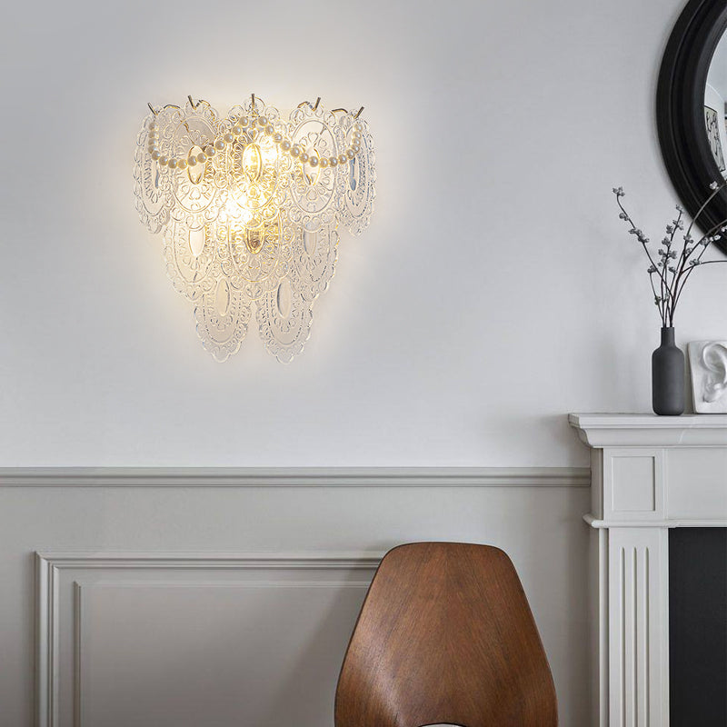 Glass feather wall light with a delicate feather pattern, enhancing a modern interior.