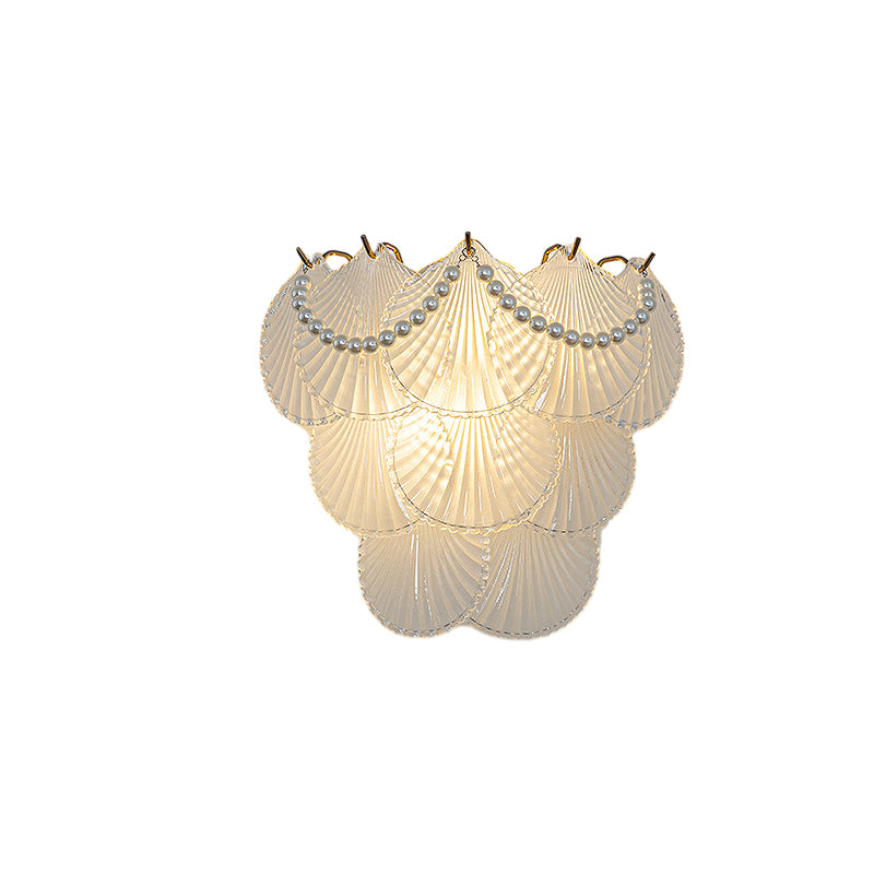 Glass feather wall light with a feather-inspired design, illuminating a modern room.