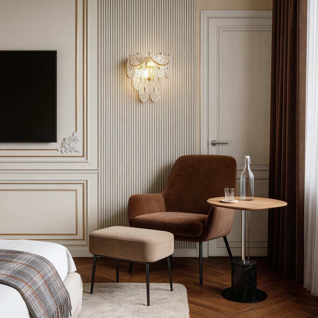 Elegant glass feather wall light illuminating a modern bedroom with a cozy armchair and wooden floor.