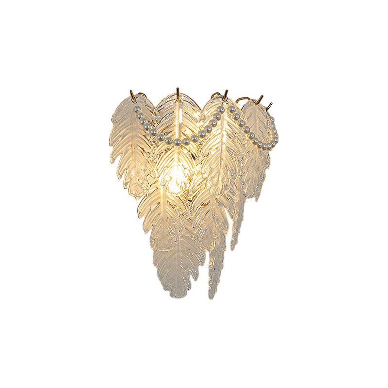 Glass feather wall light with a unique feather pattern, providing ambient lighting.