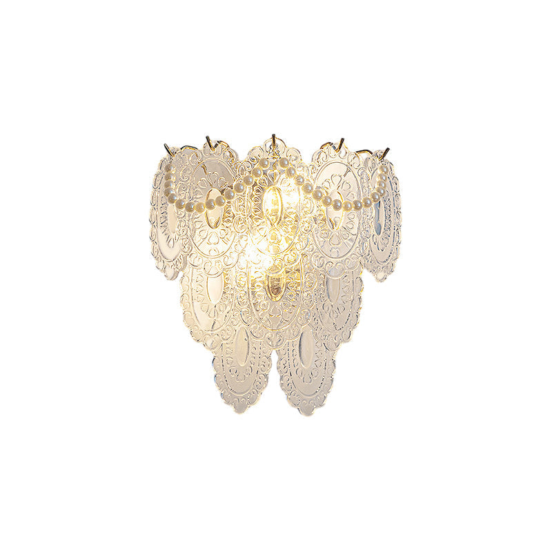 Glass feather wall light with a warm yellow light, enhancing a cozy interior.