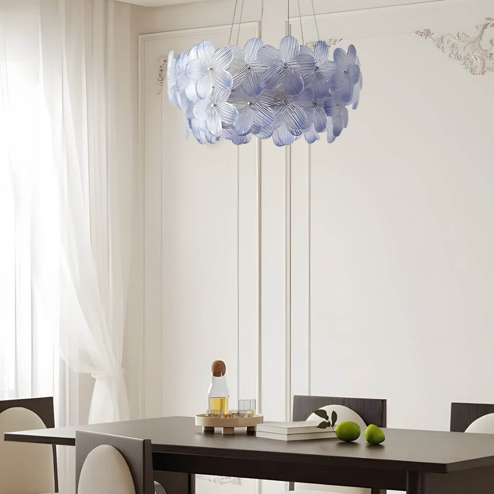 Glass flower chandelier with a close-up of its illuminated glass petals and gold frame.