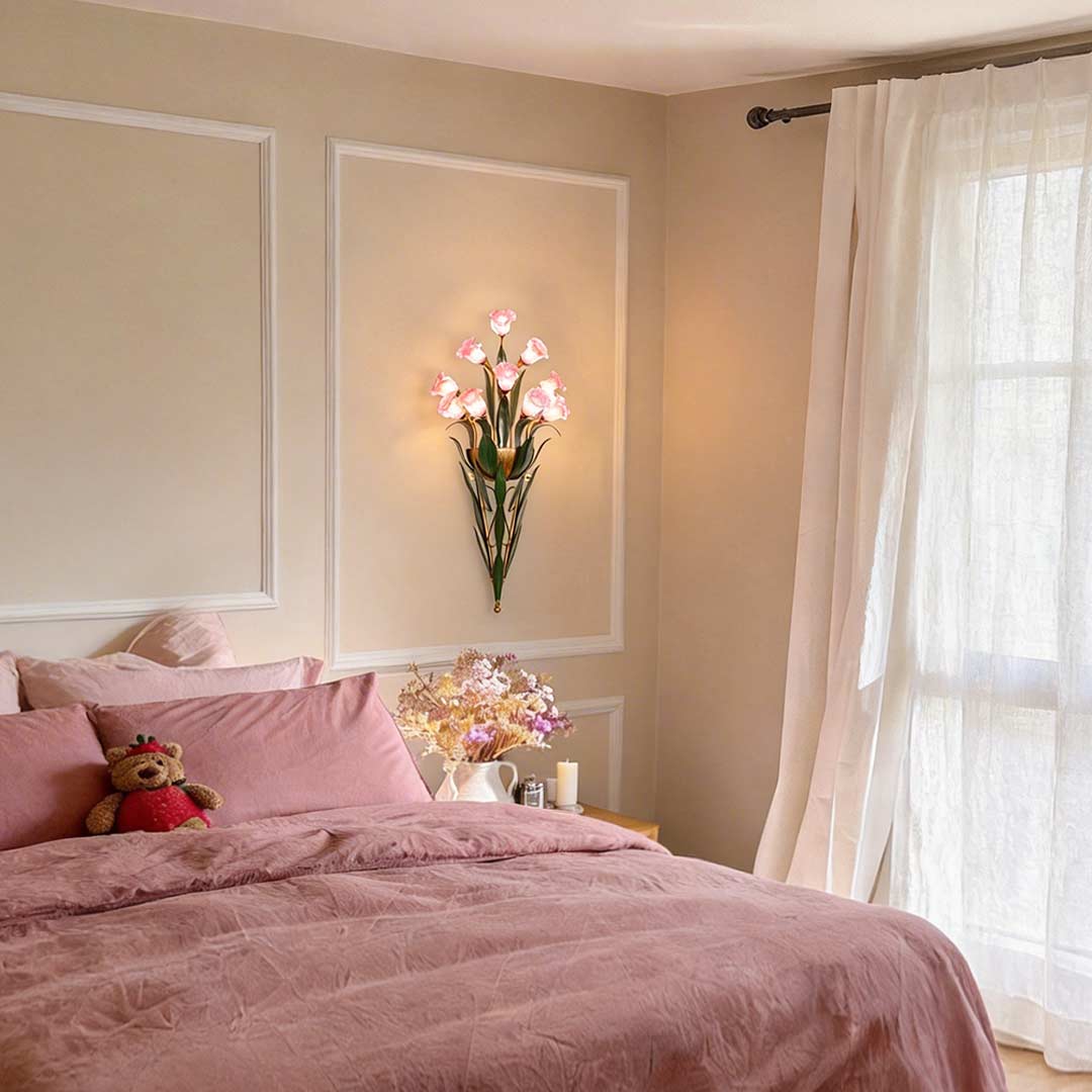Glass flower sconce with pink blooms, illuminating a contemporary bedroom with soft light.