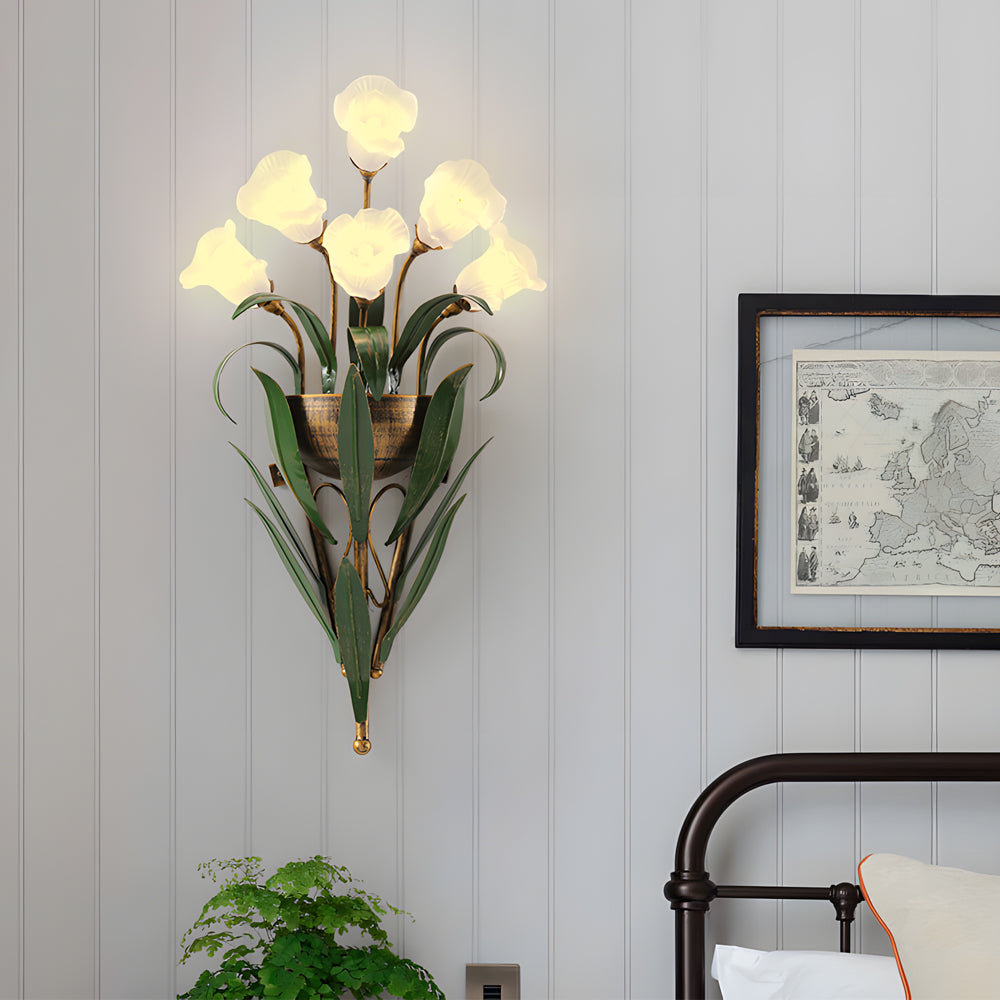 Glass flower sconce with white blooms, mounted on a light-colored wall in a stylish interior.