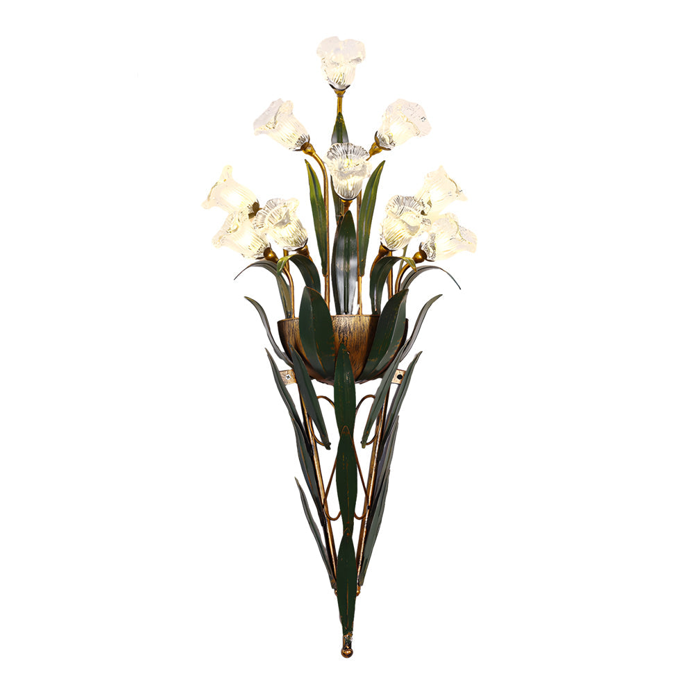 Glass flower sconce with white blooms, mounted on a plain wall in a modern home.