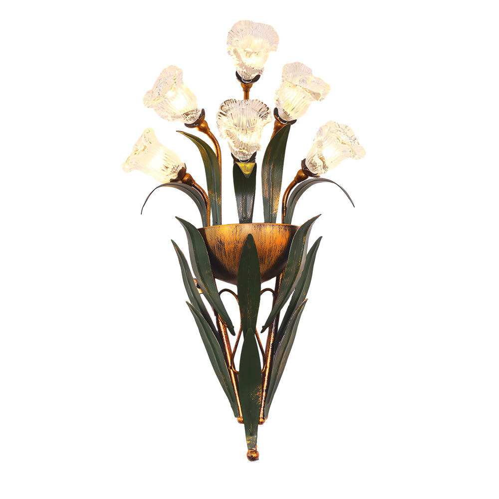 Glass flower sconce with white blooms, mounted on a white wall in a minimalist room.