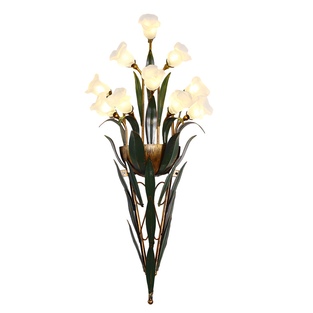Glass flower sconce with white flowers, providing elegant lighting in a stylish room.