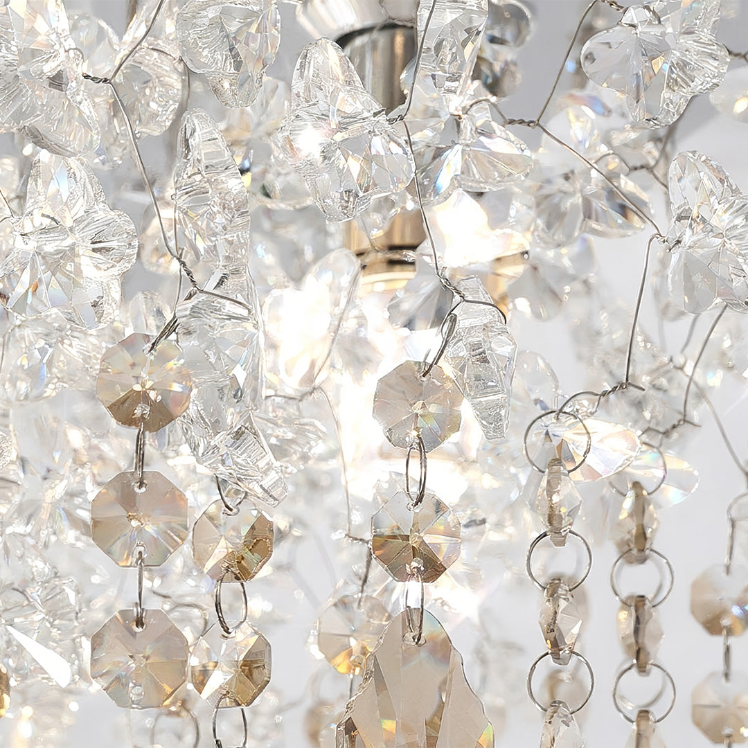 Close-up detail of a glass flush mount ceiling light with faceted crystal drops and warm illumination.