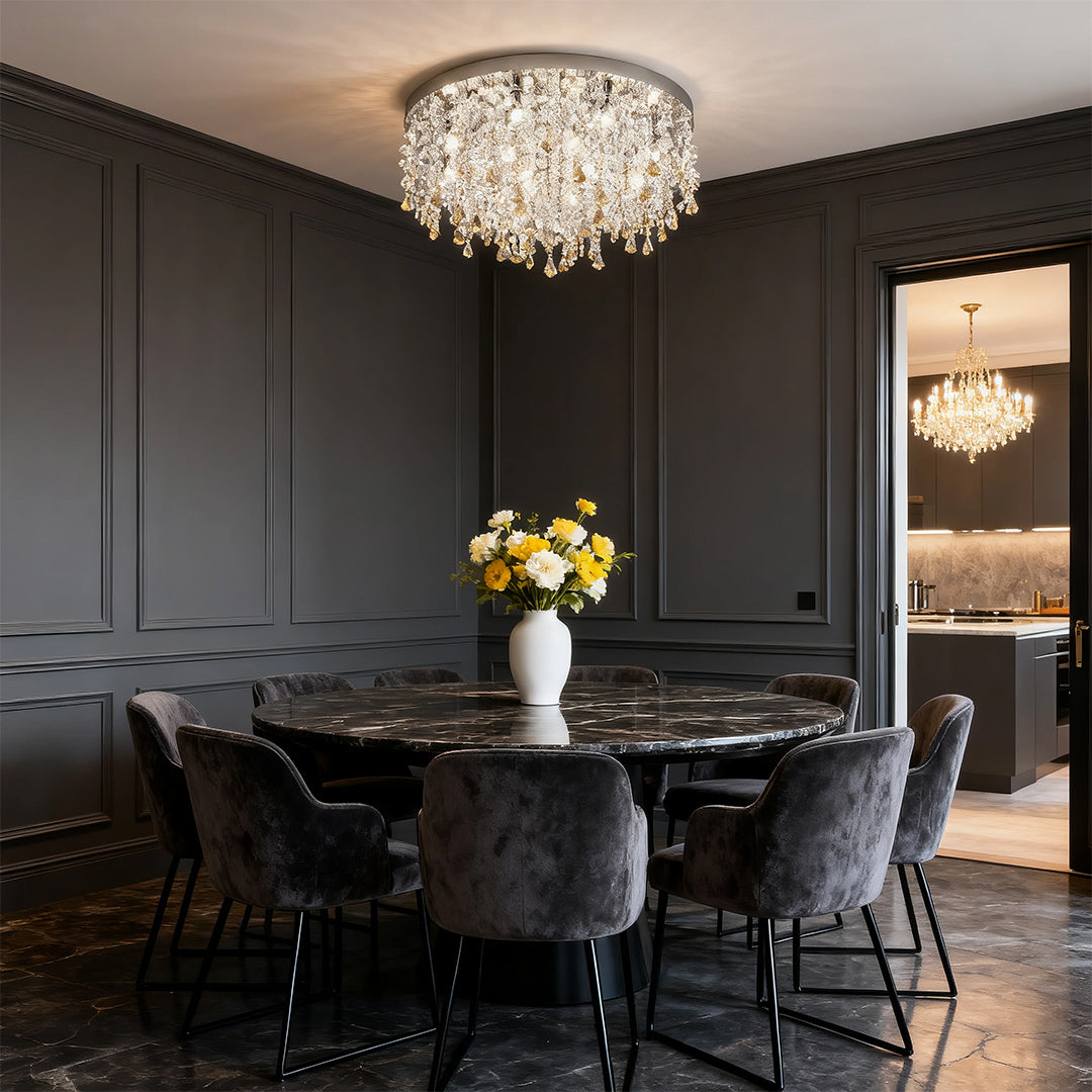 Glass flush mount ceiling light above a dark modern dining room table with crystal accents.