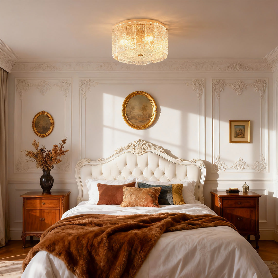 Glass flush mount lighting creating warm ambiance in elegant bedroom with rust bedding and gold accents