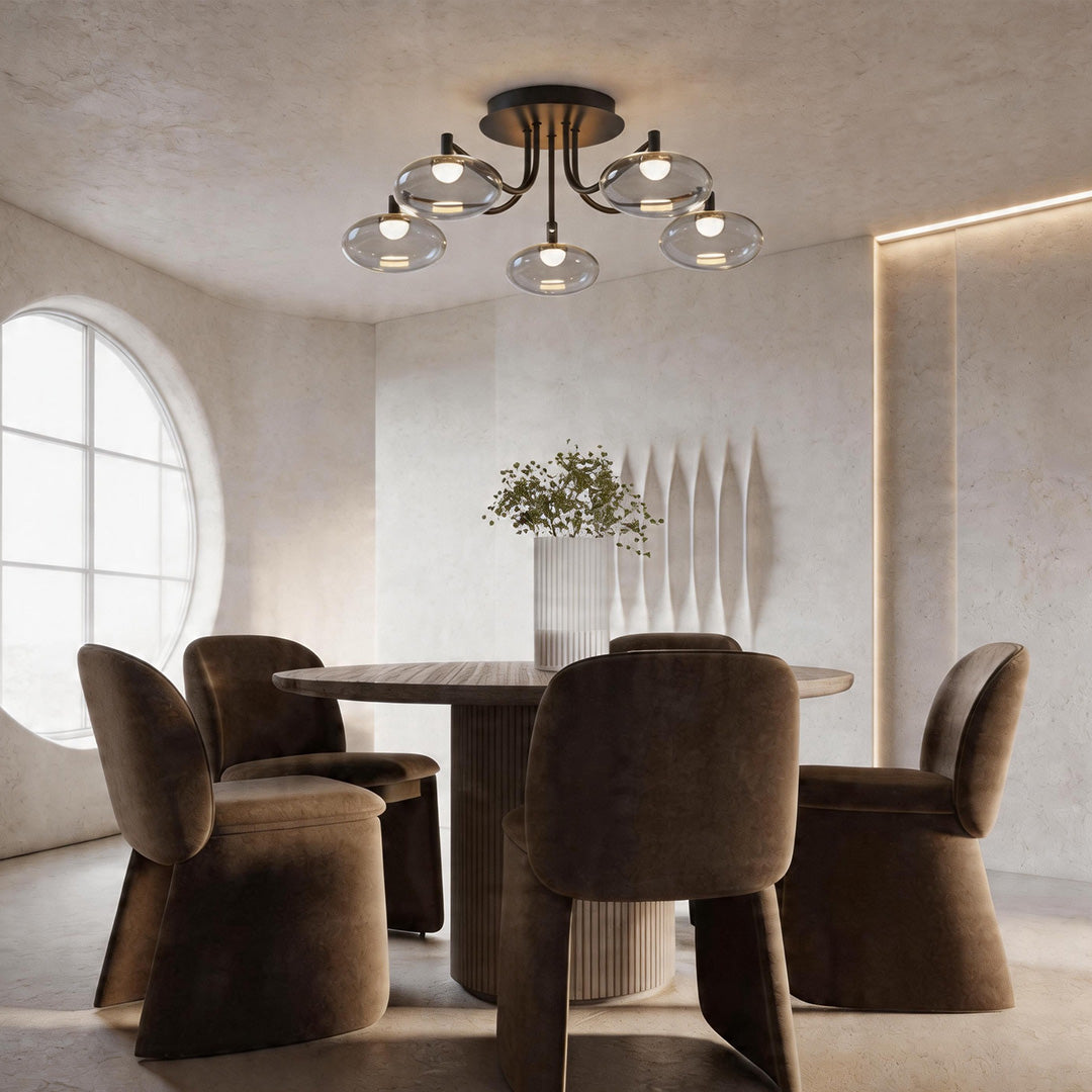 Glass flush mount ceiling light with multiple clear globes illuminating a modern dining room.