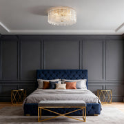 Glass flush mount lighting enhancing sophisticated bedroom with navy upholstered bed and paneled walls