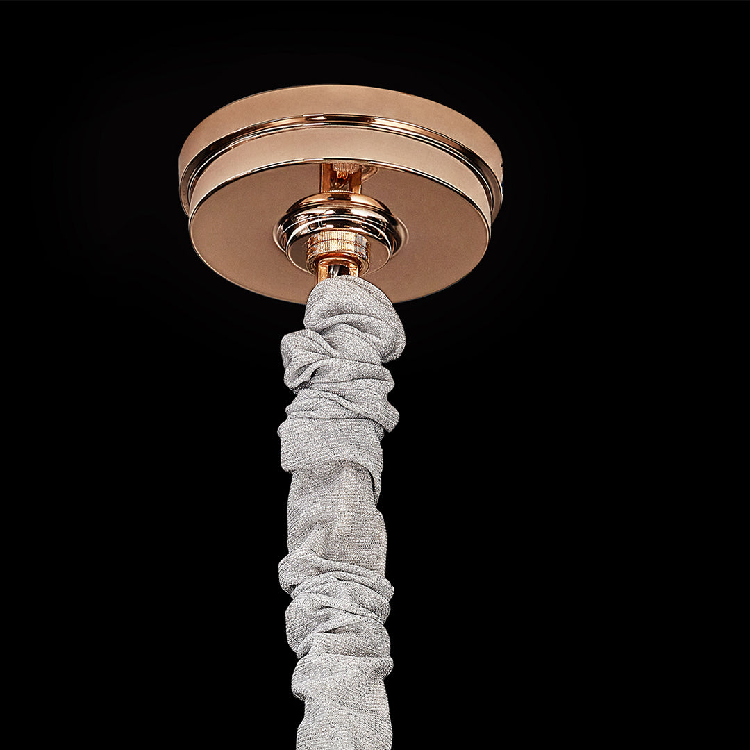 Close-up of ceiling canopy and gold finish of glass fringe chandelier.