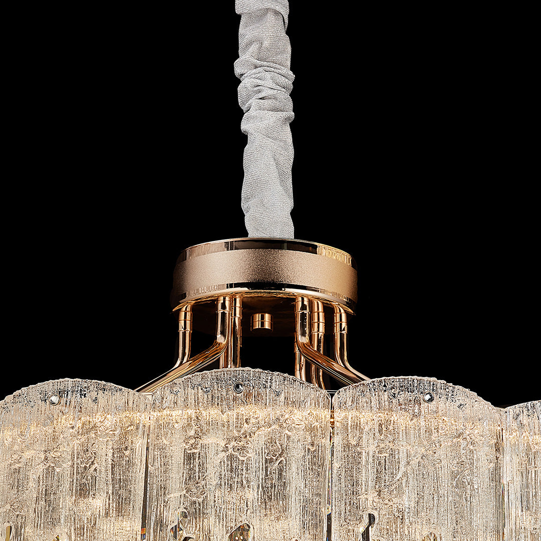 Close-up of ceiling canopy and gold finish of glass fringe chandelier.