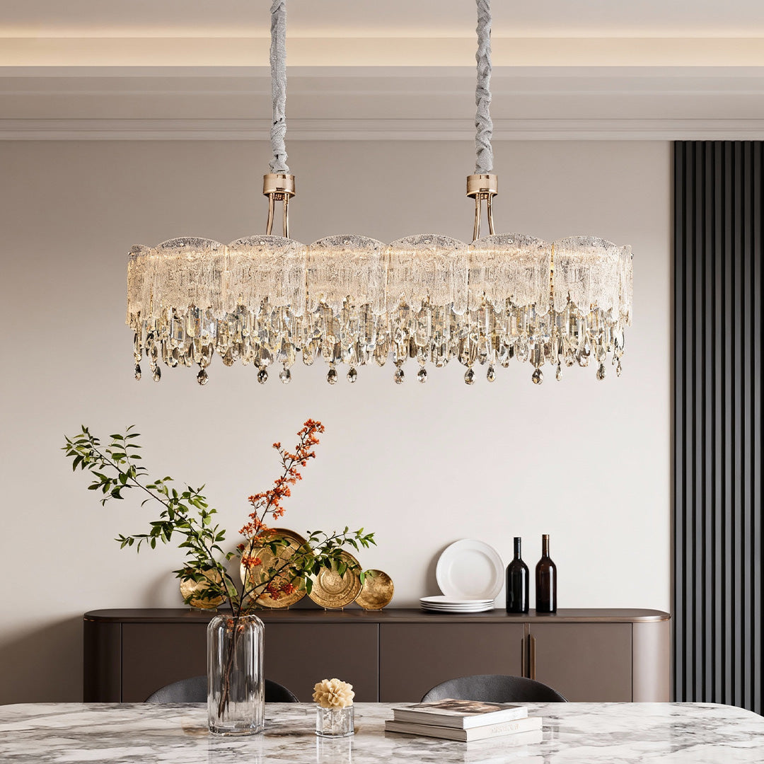 Close-up of glass fringe chandelier showing detailed crystal strands and reflections.