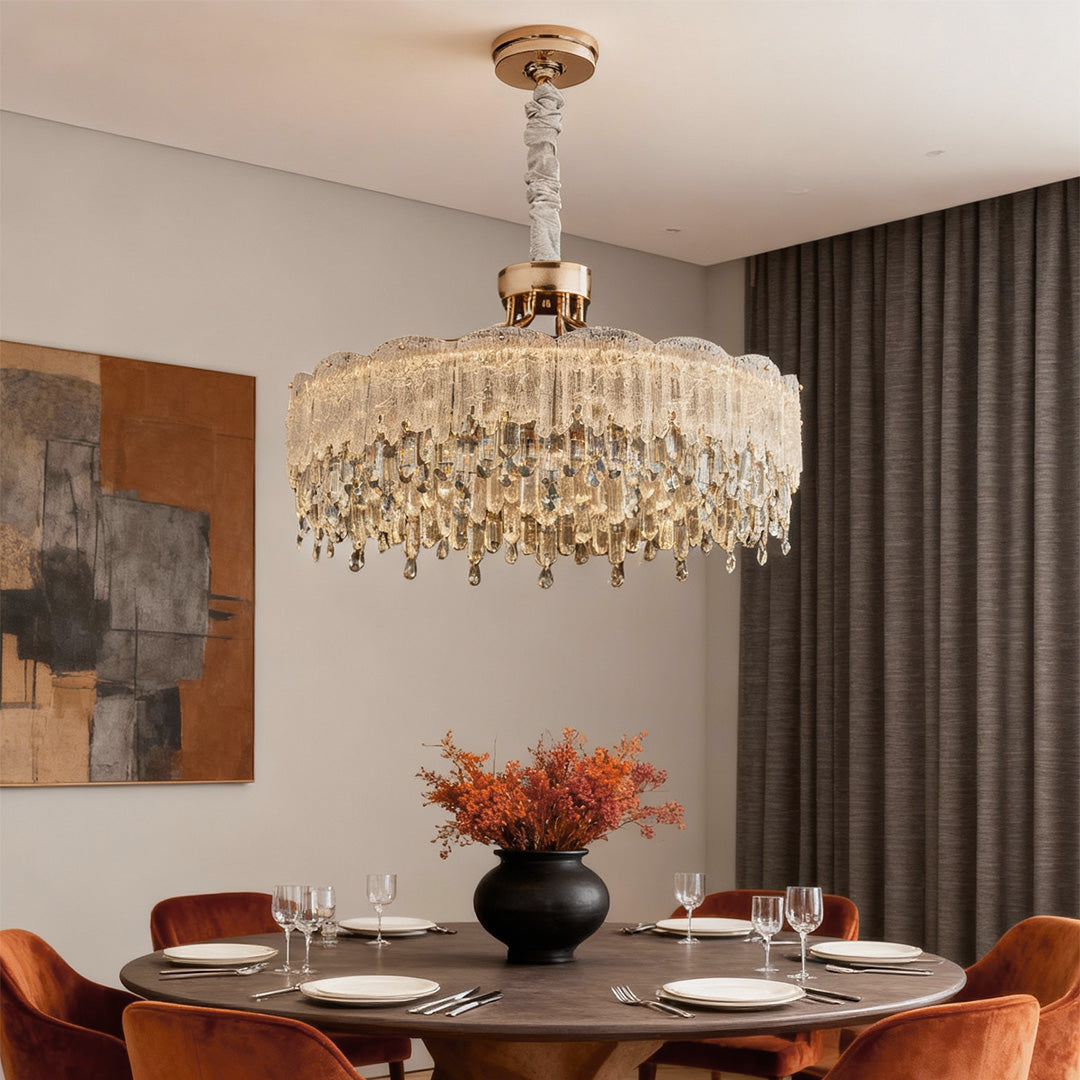 Glass fringe chandelier brightening dining space with modern marble decor.