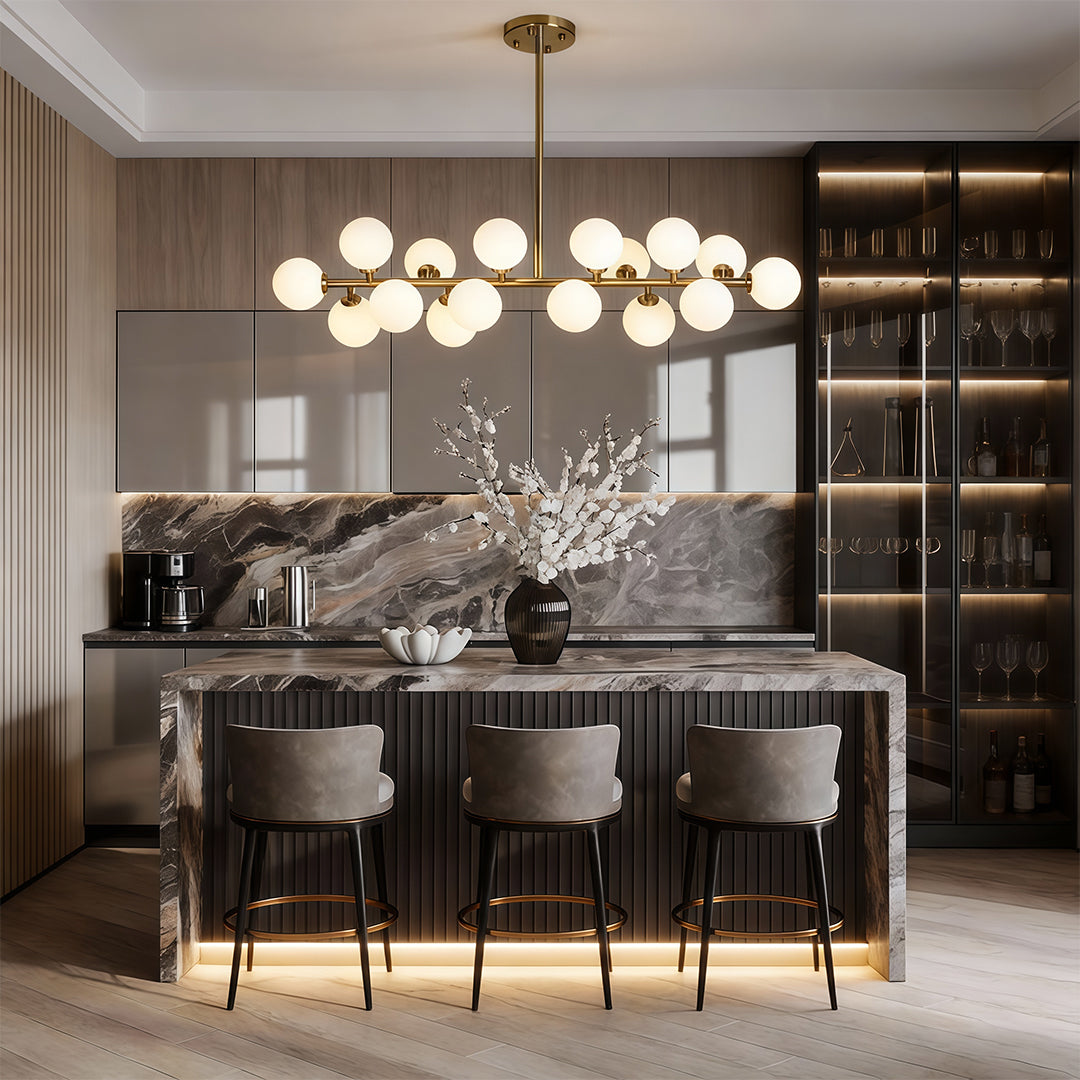 Glass globe linear chandelier providing soft illumination above a contemporary kitchen island.