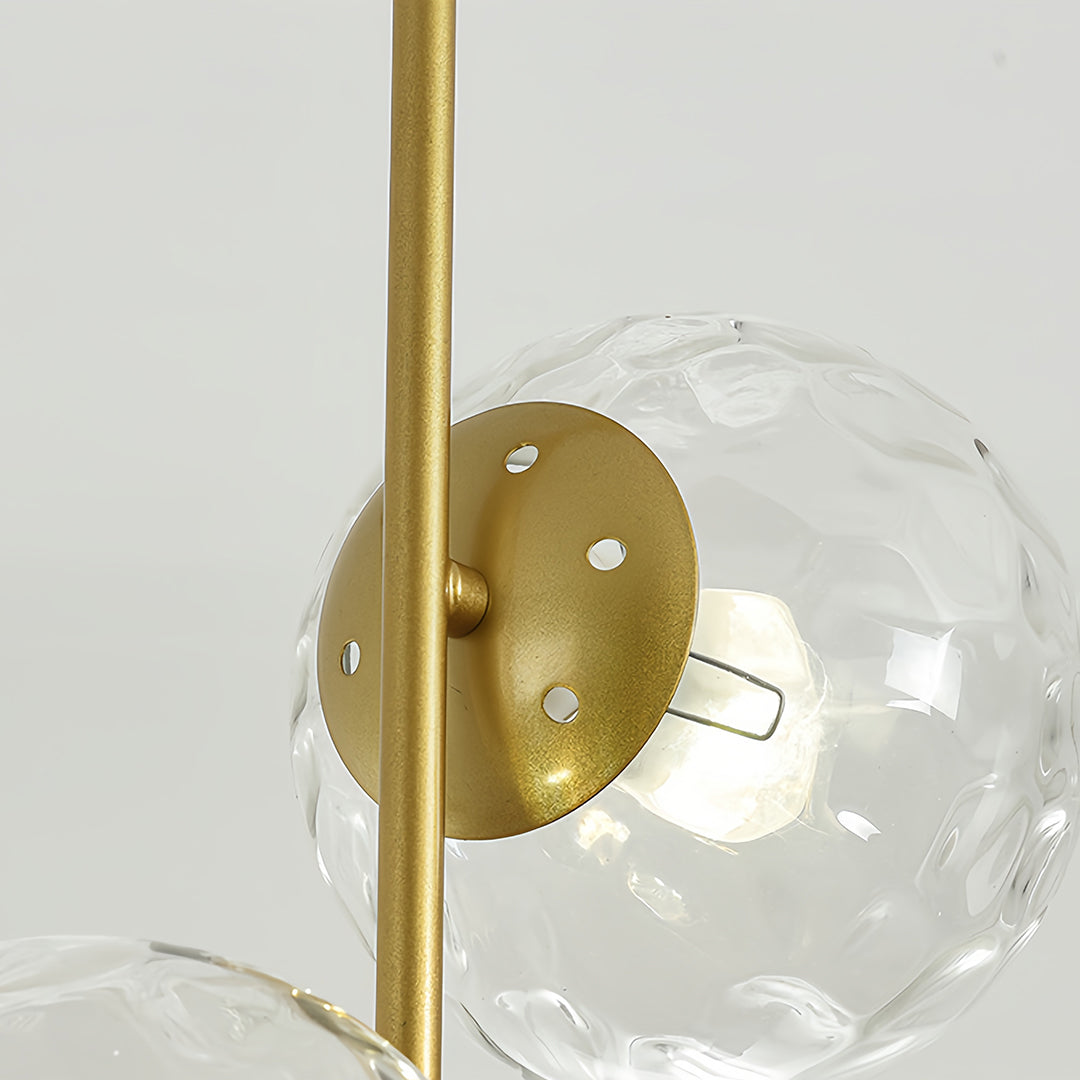 Glass hanging pendant light with faceted clear sphere creating brilliant light refraction and sparkle effects