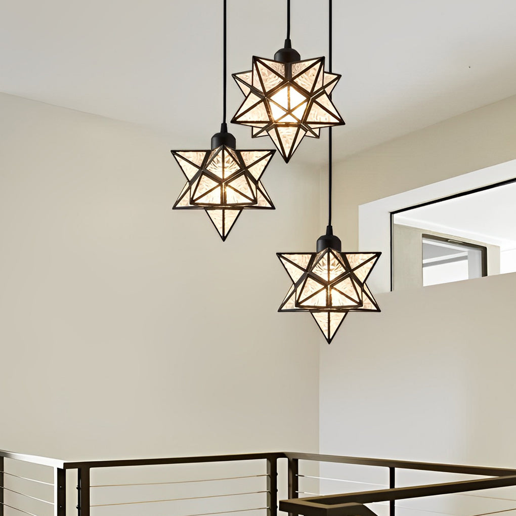 Pair of glass Moravian star pendant lights hanging elegantly in a bright and airy living space.