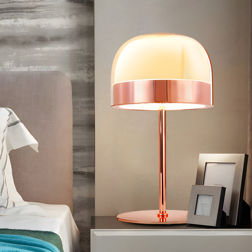 Glass mushroom table lamp with a copper accent, illuminating a cozy bedroom corner.