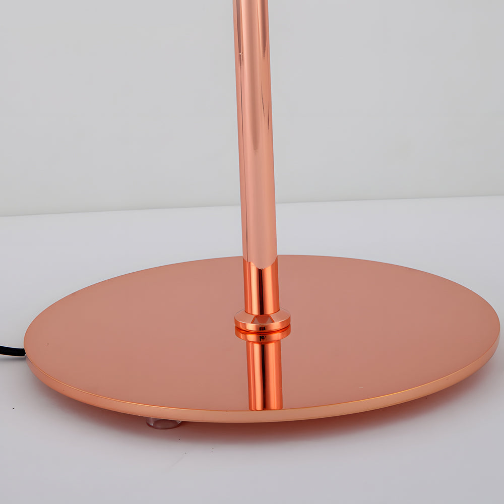Glass mushroom table lamp with a copper base, placed on a white table in a modern interior.