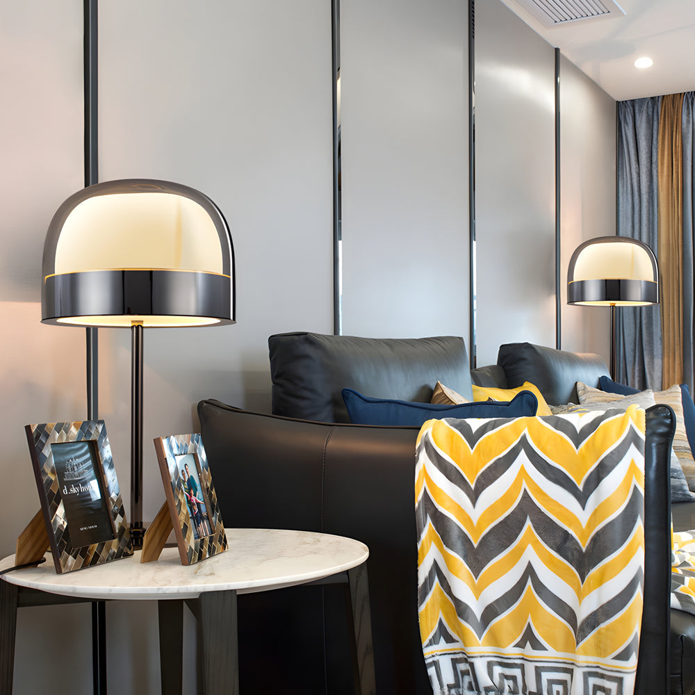Glass mushroom table lamp with a white shade, placed on a modern bedside table.