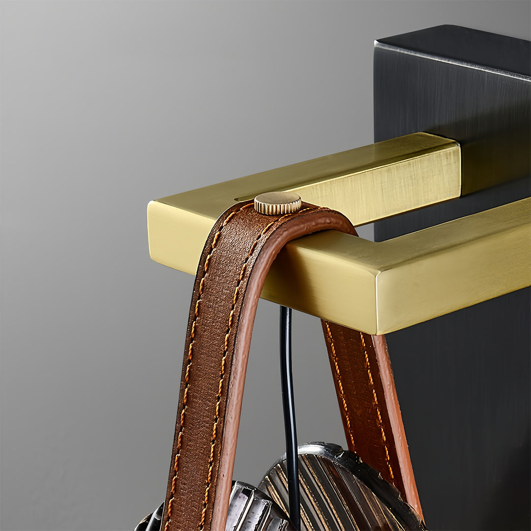 Detail view of hanging glass pendant light showing brass accents and leather cord suspension