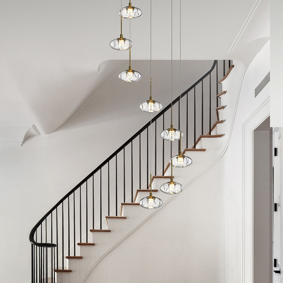 Spectacular chandelier for tall ceilings featuring glass pendant cluster illuminating elegant staircase in contemporary home