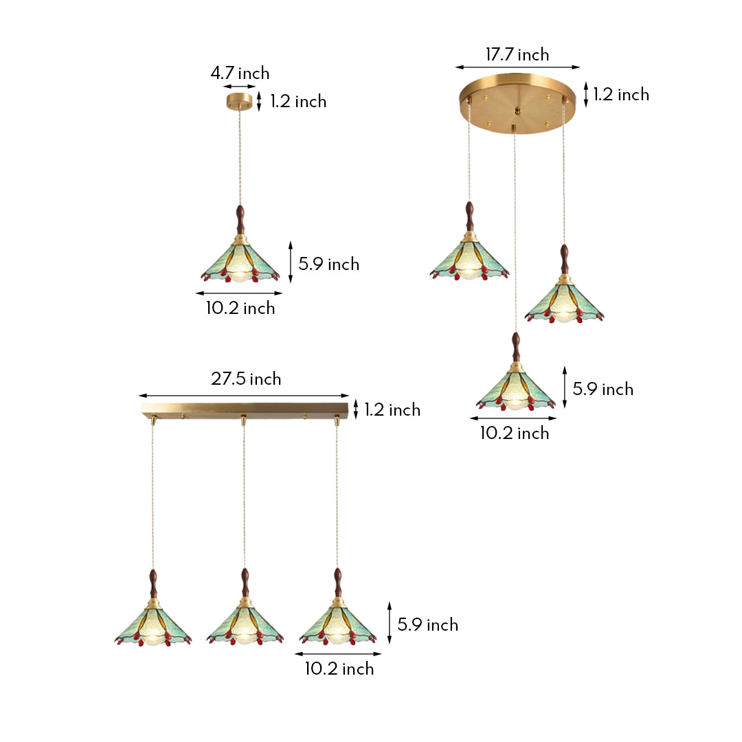Three glass pendant lights with gold frames and green floral glass shades, creating a vintage ambiance.