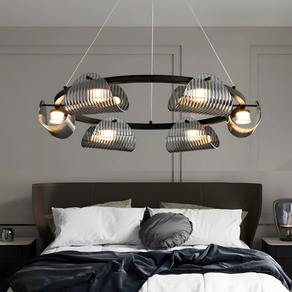 Glass ring chandelier with a minimalist design, hanging above a modern dining table.