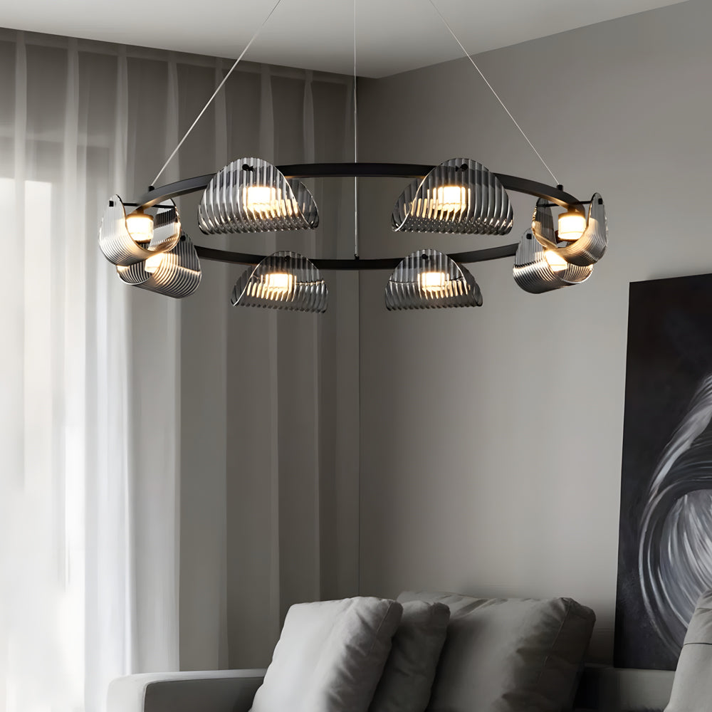 Glass ring chandelier with a unique ring structure, providing warm light in a bedroom.