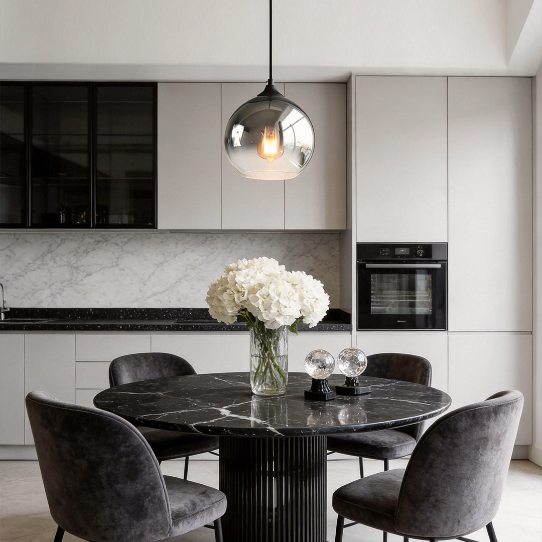 Glass round pendant light serving as an accent light in a bedroom.
