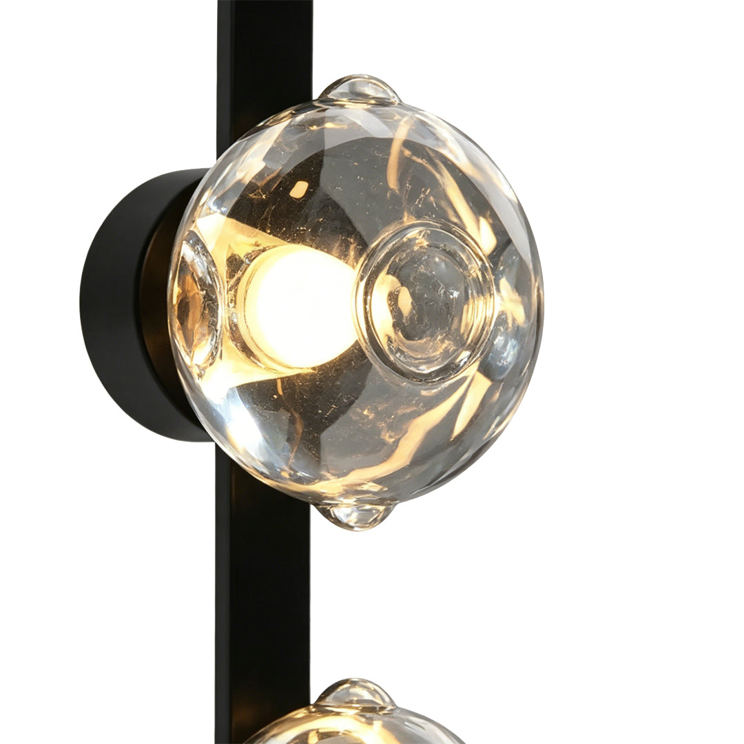 Close-up of textured bubble glass wall sconce with warm LED light.