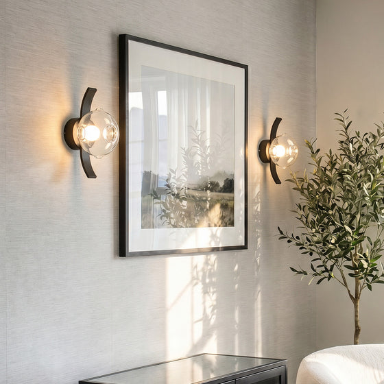 Modern glass wall sconce lighting in a cozy living room setting.