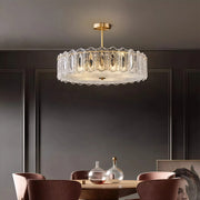 Modern luxury chandeliers style glass semi flush mount lighting above elegant dining table with brown chairs