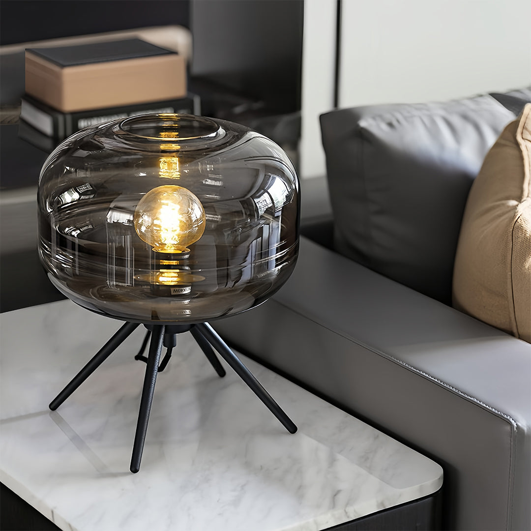 Glass small table lamp with ribbed dome shade positioned on modern side table in contemporary interior