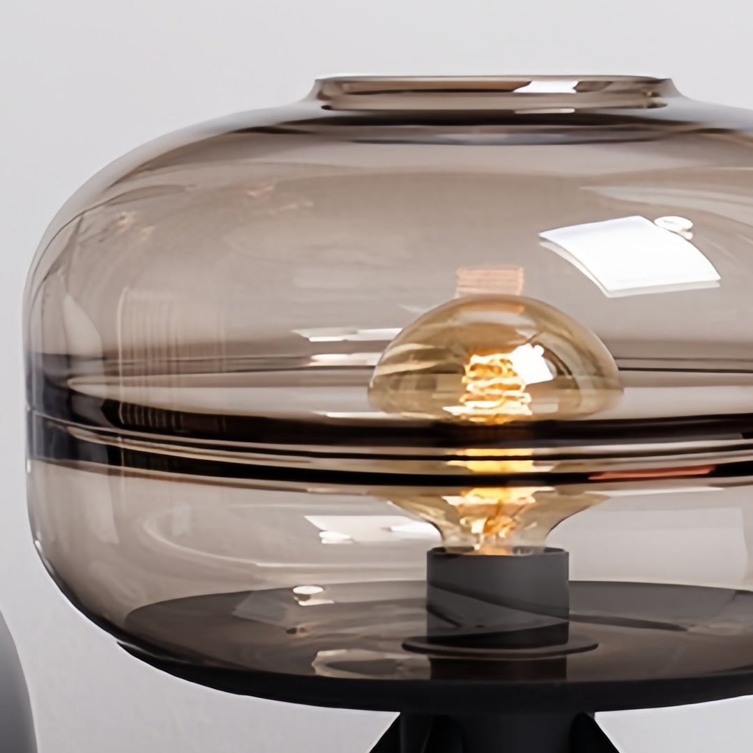 Glass small table lamp with smoke-tinted shade providing cozy lighting detail showing premium construction quality