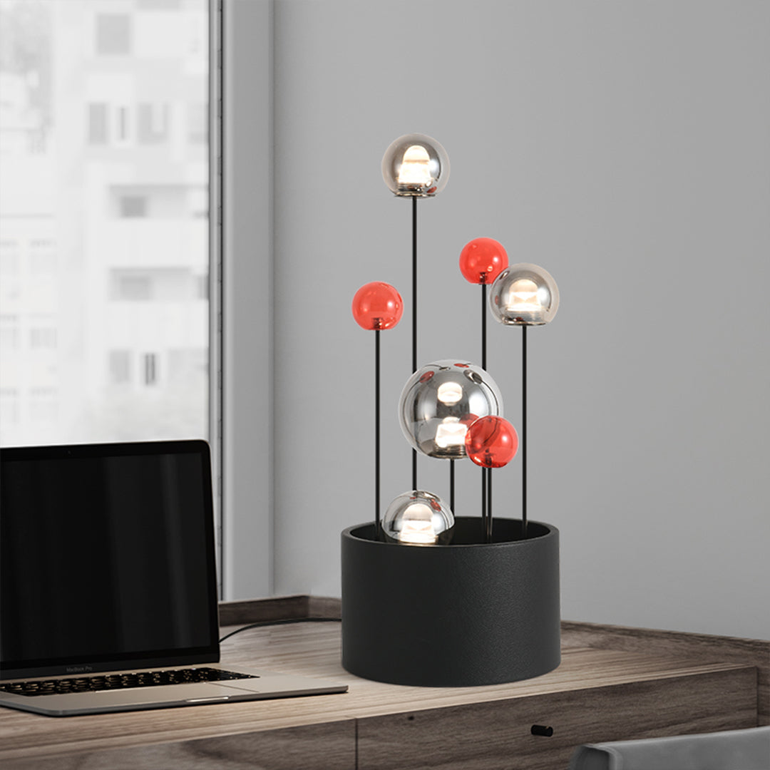 Modern glass sphere table lighting displayed on wooden surface in contemporary interior space