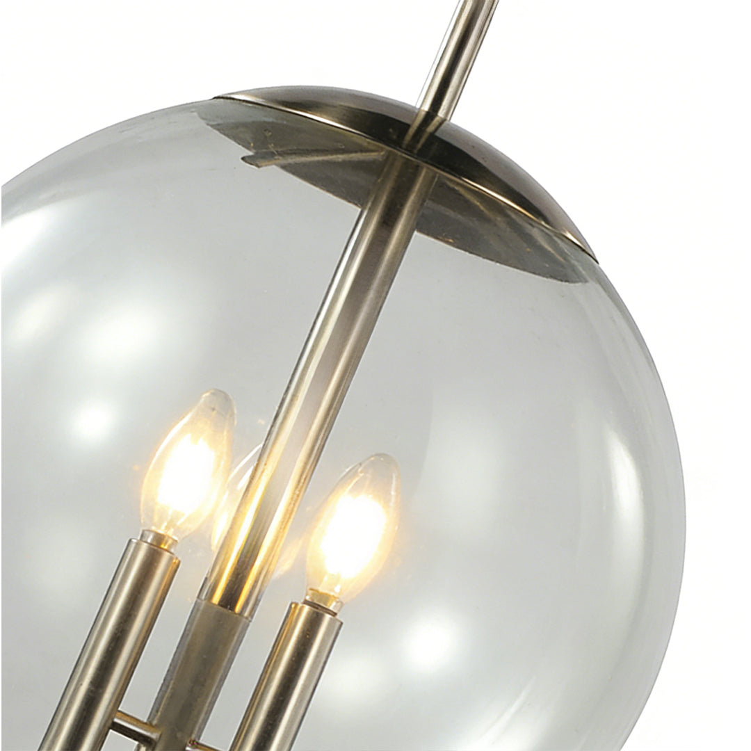 Close-up of a glass orb pendant light highlighting the transparent globe, internal bulbs, and refined metal details in a modern lighting fixture.