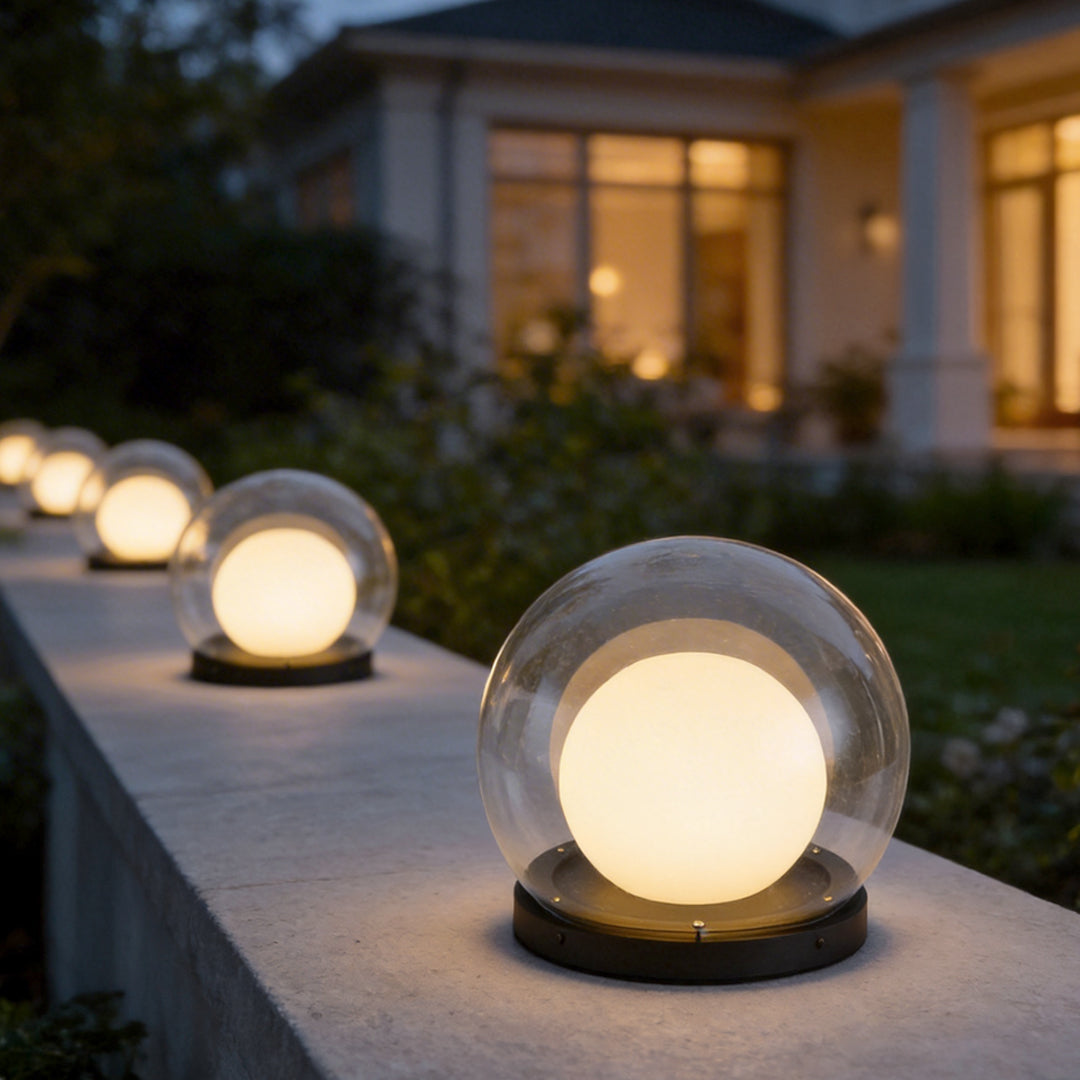 Global pillar lights with a close-up of their transparent globe and warm light.