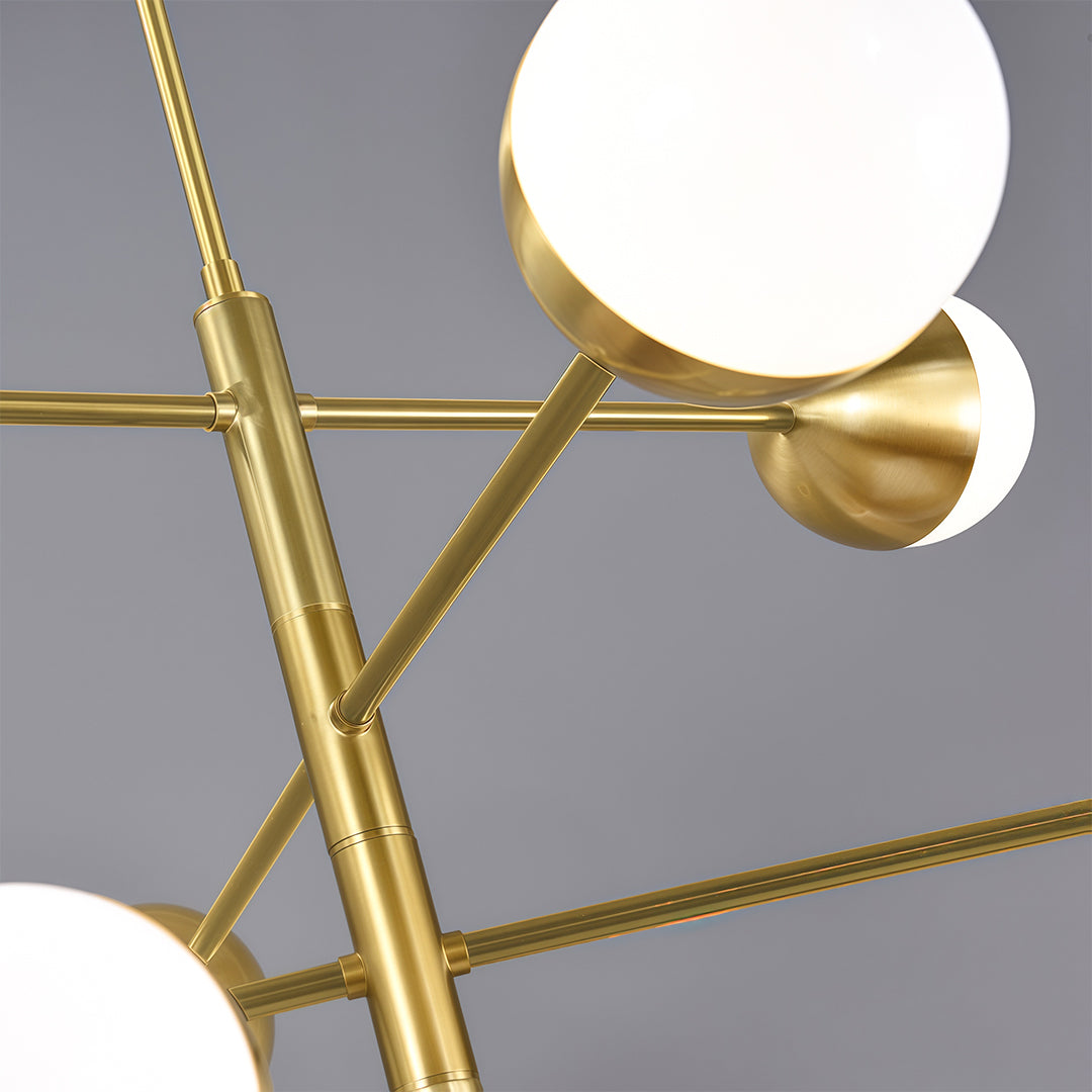 Modern luxury chandeliers perspective highlighting geometric brass structure and globe arrangement
