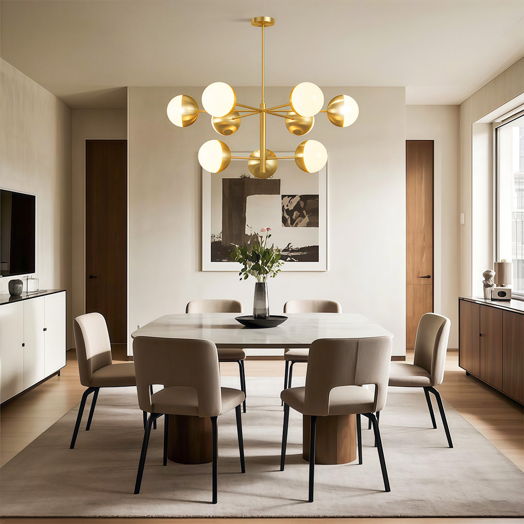 Modern luxury chandeliers above round dining table in sophisticated neutral interior